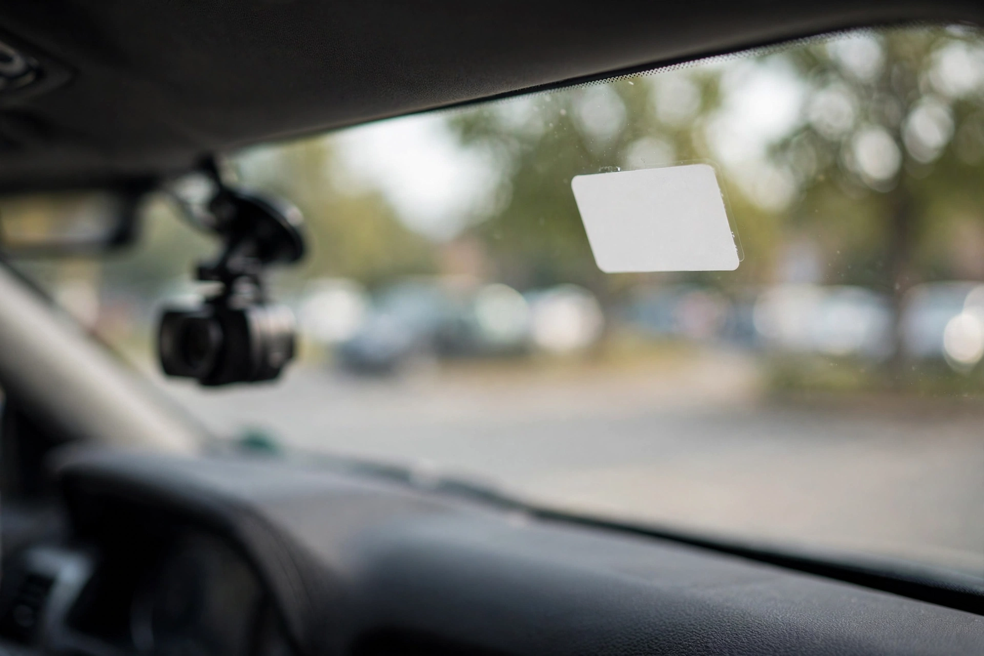 Small blank recording-notice decal on a car window, an important detail when choosing the best dash cam for Uber drivers